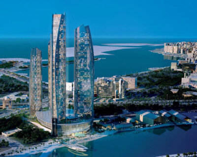 Aerial view of the Jumeirah at Etihad Towers in Abu Dhabi, showcasing its proximity to the coastline and nearby urban landscape, ideal for those attending the Abu Dhabi Grand Prix.