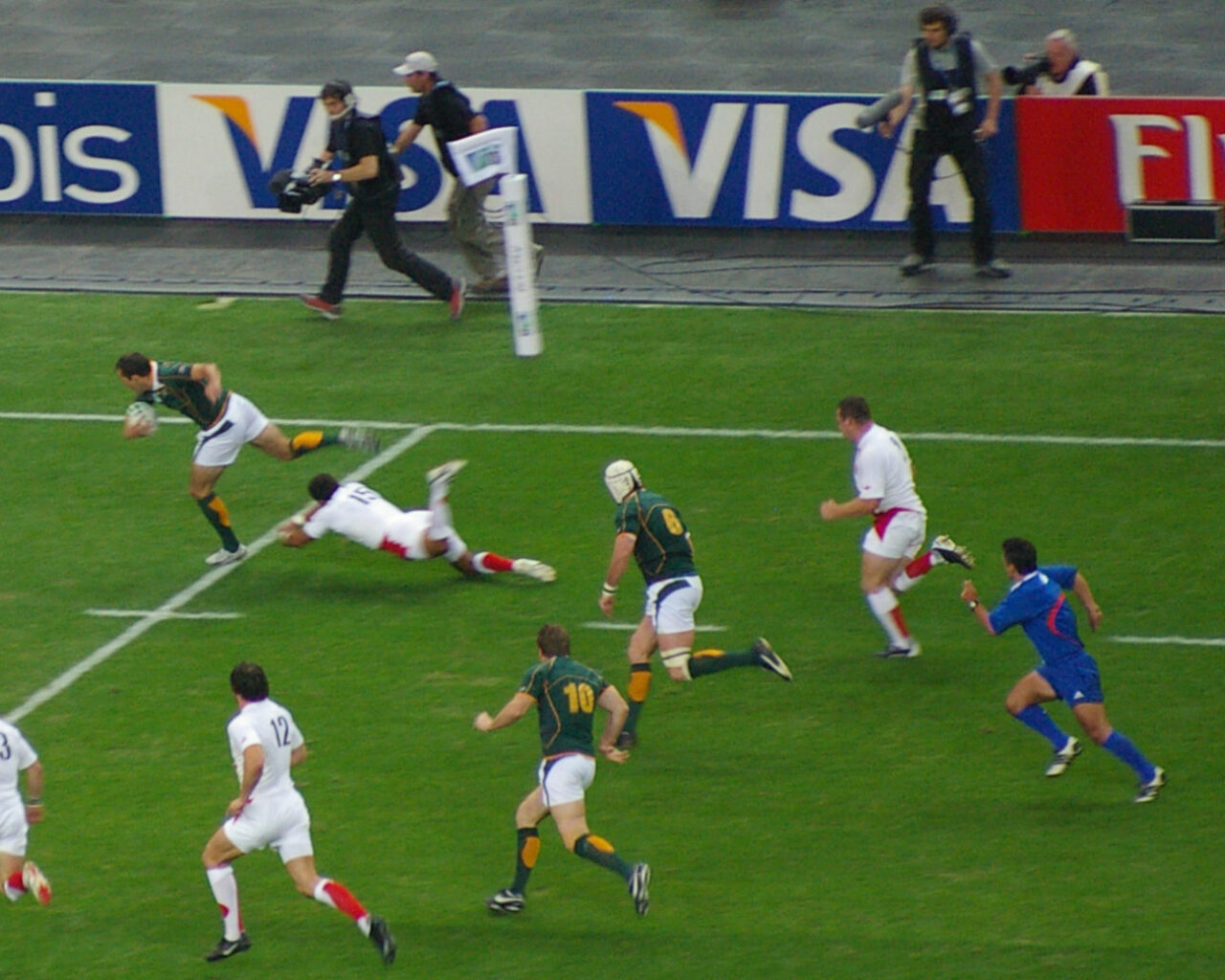 Players from different teams compete in an intense Rugby World Cup match, highlighting the global appeal of rugby and its travel, hotel, and ticket package opportunities.