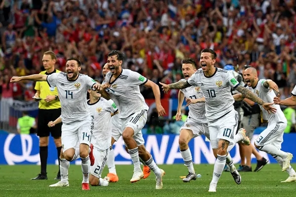 Soccer players celebrate enthusiastically during a match, capturing the excitement typical at a World Cup event, a highlight for luxury travel packages focused on global sporting experiences.