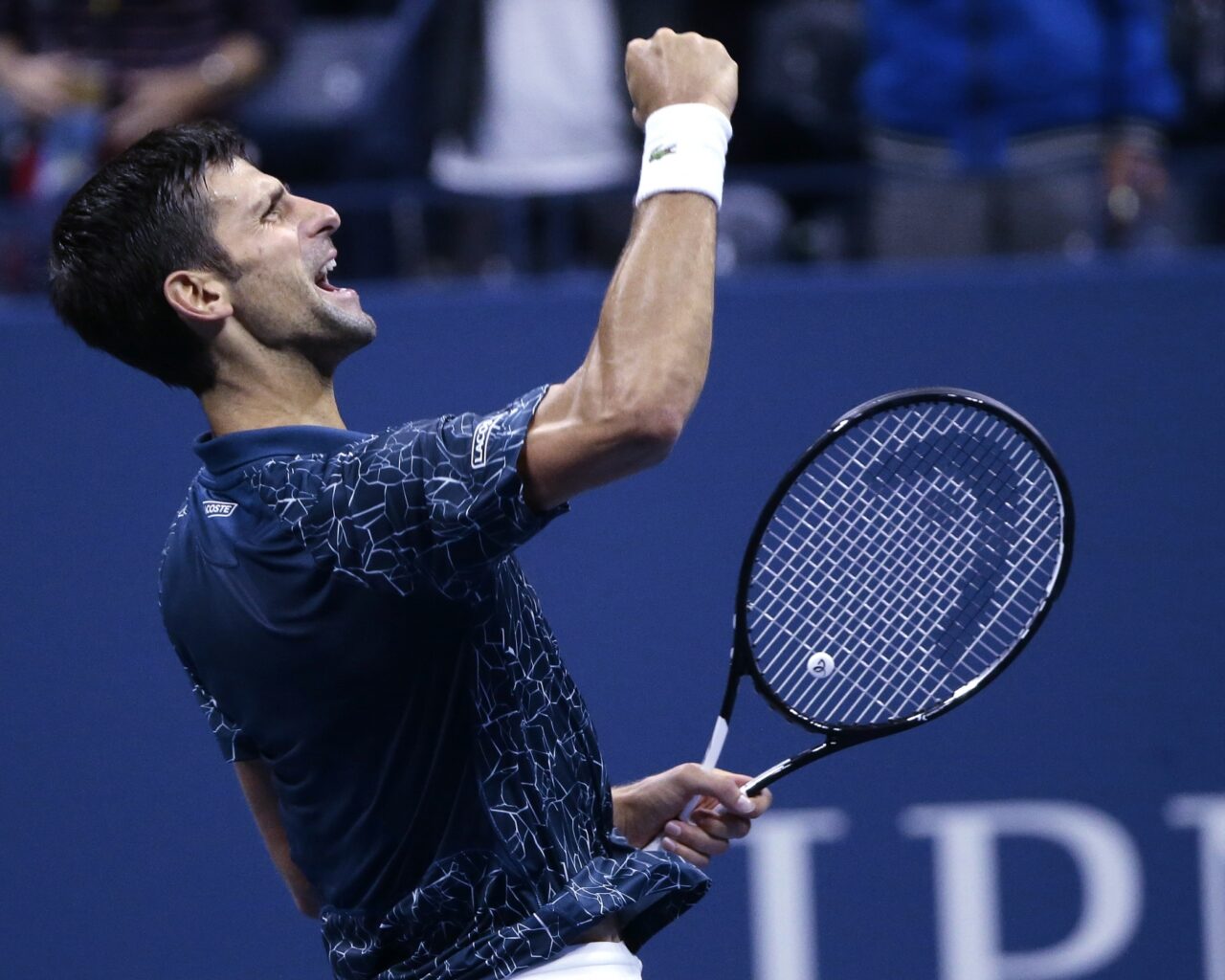 Tennis player celebrating a victory on the court at the US Open Tennis event, capturing the excitement of the tournament.