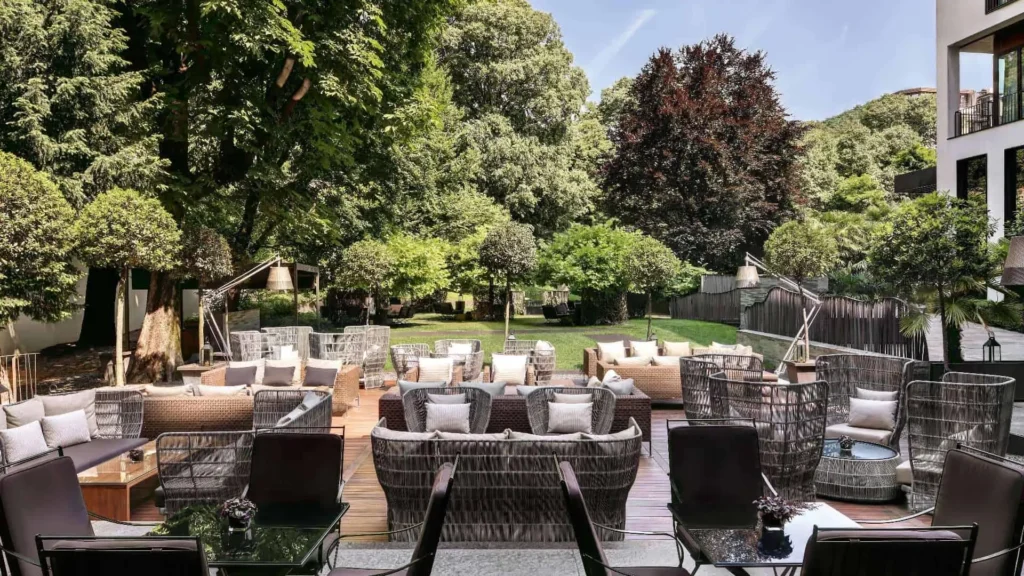 Lush garden setting at Bvlgari Hotel Milano featuring elegant outdoor furniture, ideal for relaxation near Monza, a key area for the Italian Grand Prix.