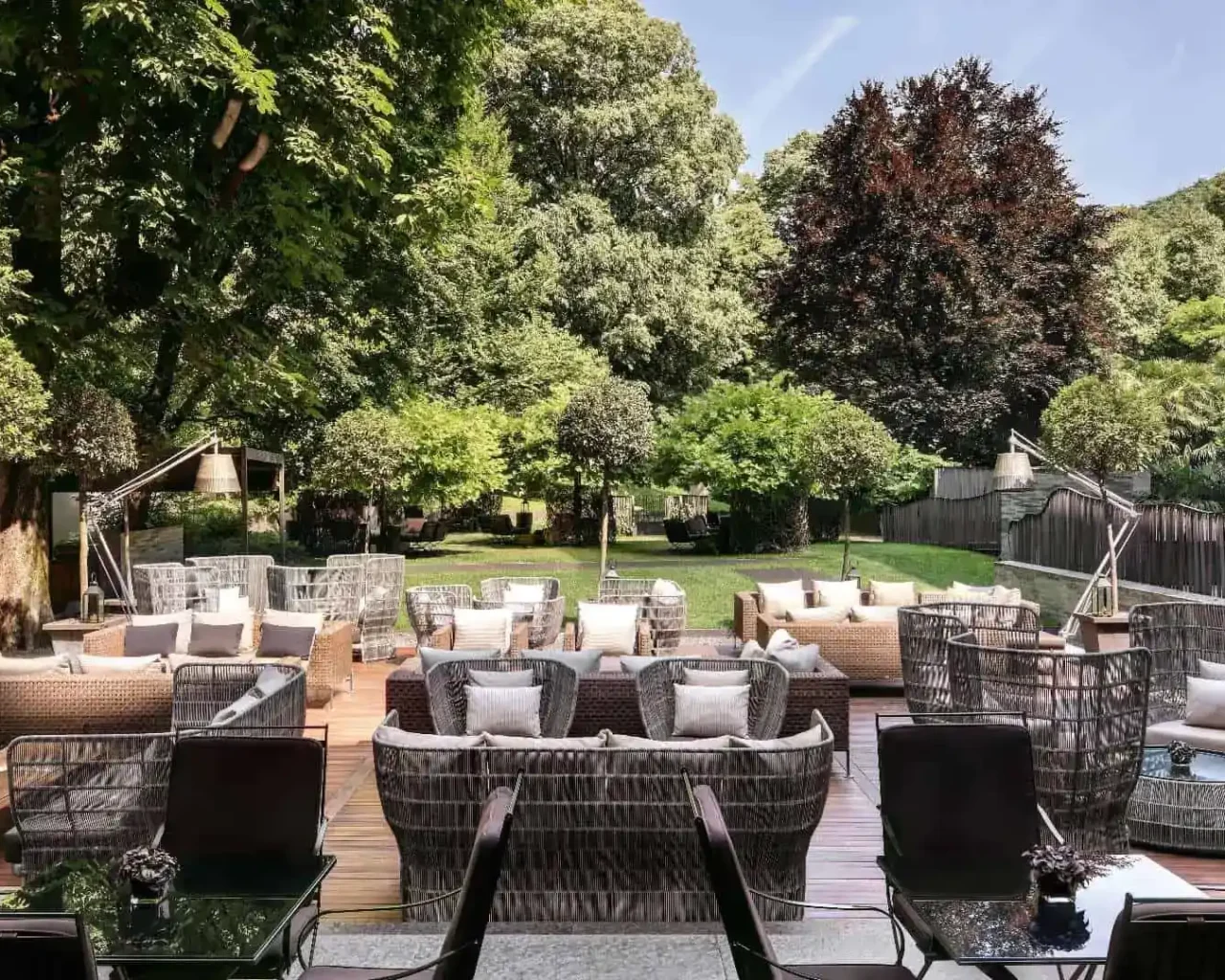 Lush garden setting at Bvlgari Hotel Milano featuring elegant outdoor furniture, ideal for relaxation near Monza, a key area for the Italian Grand Prix.
