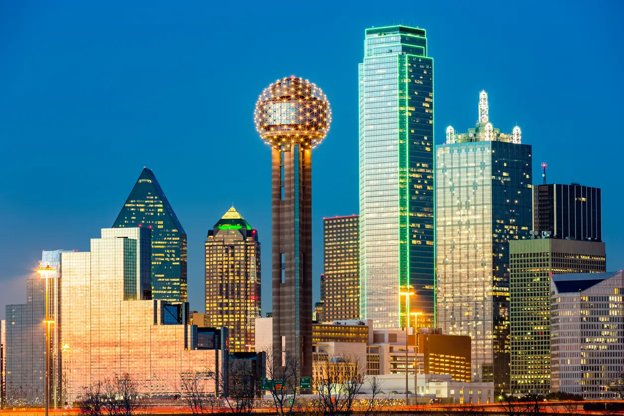 Dallas skyline at dusk featuring the iconic Reunion Tower and modern skyscrapers, highlighted as a host city for the World Cup with AT&T Stadium known for its large capacity.