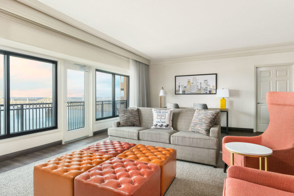 Luxurious hotel room at The Galt House Hotel in Louisville, featuring stylish decor and panoramic river views, ideal for guests attending the Kentucky Derby near Churchill Downs.