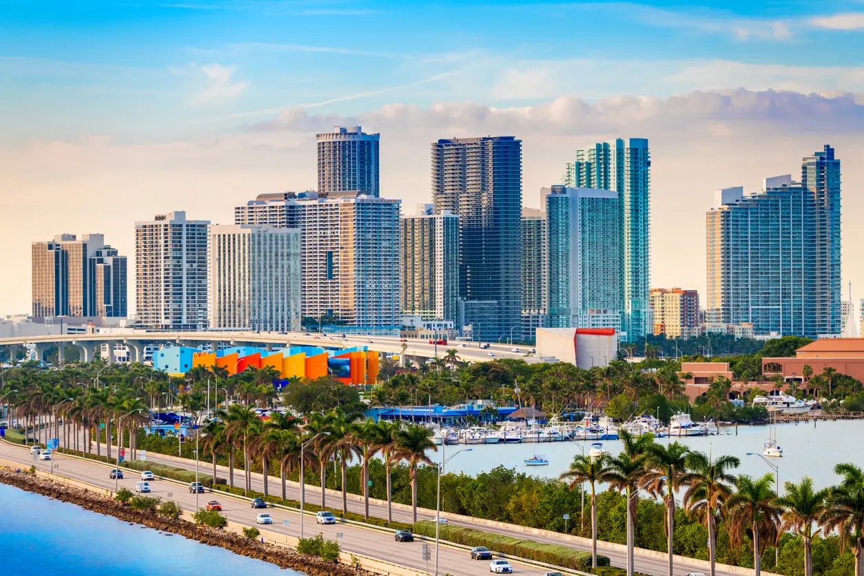 A panoramic view of Miami's skyline featuring modern high-rise buildings and the vibrant oceanfront near Hard Rock Stadium, highlighting the city as a World Cup host venue.