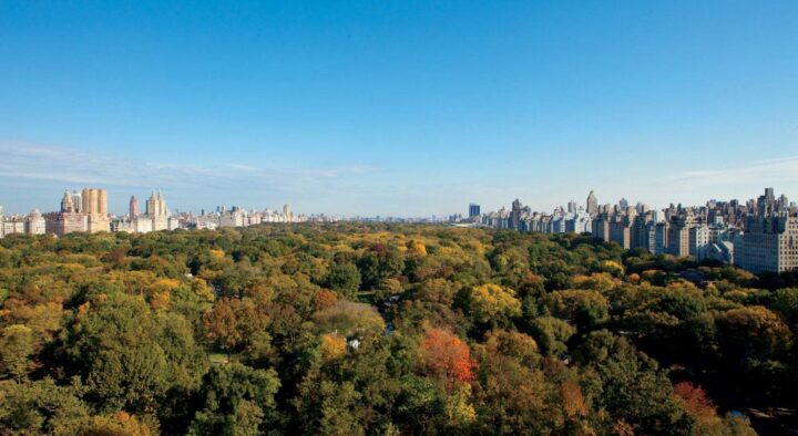 Aerial view of Central Park surrounded by the New York skyline during autumn, showcasing potential luxury accommodations for the Ryder Cup.