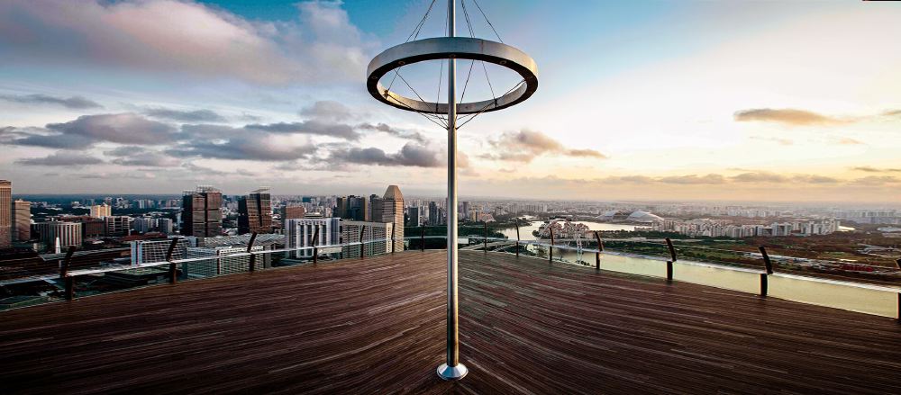 View from the observation deck at Marina Bay Sands showing a modern cityscape of Singapore, ideal for guests looking for luxury accommodations near the Singapore Grand Prix.