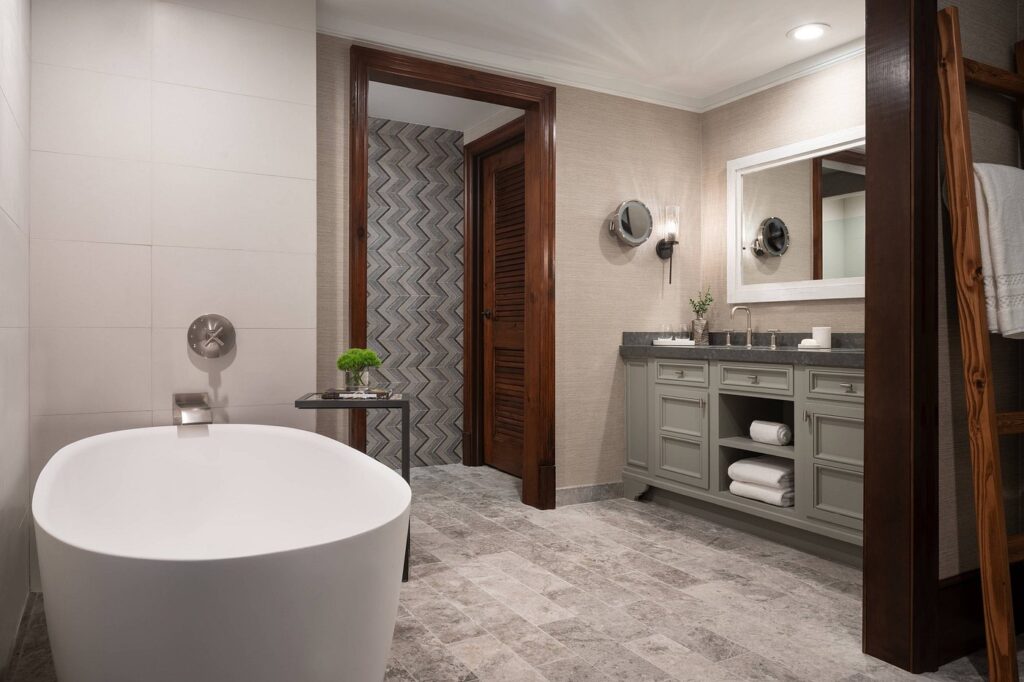 Luxurious bathroom suite at The Ritz-Carlton Reynolds, Lake Oconee, featuring a freestanding bathtub, elegant vanity area, and modern fixtures, near Augusta, ideal for Masters Augusta accommodations.
