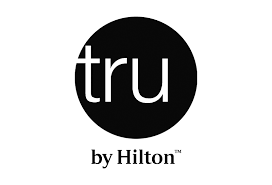 Logo for Tru by Hilton, a hotel chain offering accommodations for visitors in Indianapolis, close to the Indianapolis 500 race event.