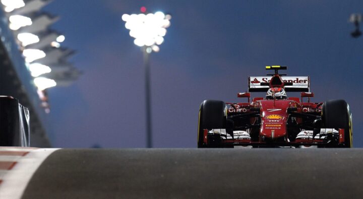 A Formula 1 car races at night during the Abu Dhabi Grand Prix, showcasing the event's atmosphere and competitive spirit.