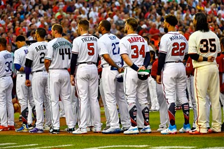 Baseball players line up on the field during the MLB All-Star Game, capturing a moment of sportive camaraderie.