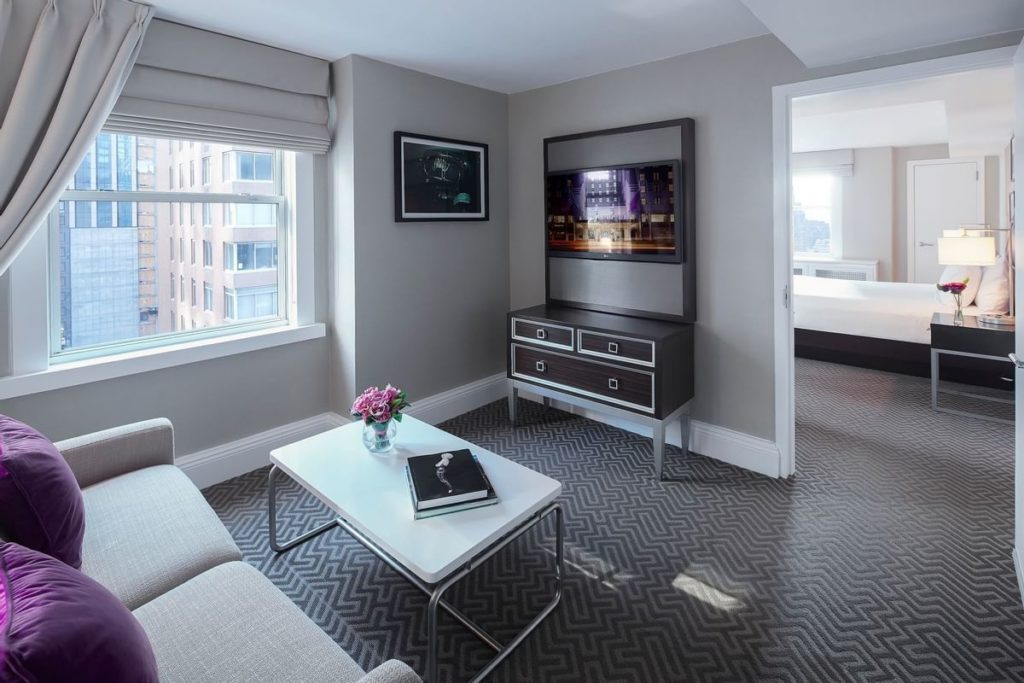 Interior view of a luxurious hotel suite at The Lexington Hotel, Autograph Collection in New York, featuring elegant furniture, modern decor, and a cityscape view, ideal for guests attending the US Open Tennis event.