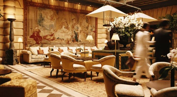 Elegant interior of a luxury hotel lounge in Monte Carlo, featuring plush seating and classical tapestries, often chosen by guests attending the Monaco Grand Prix.
