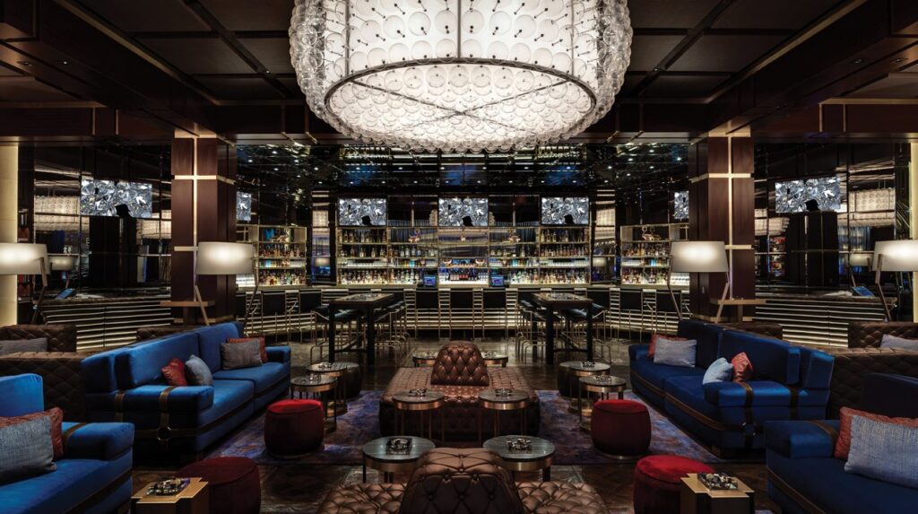 Luxurious lounge and bar area inside The Venetian Resort in Las Vegas, featuring elegant seating, a grand chandelier, and an extensive selection of beverages, ideal for Las Vegas hotels and accommodations enthusiasts.