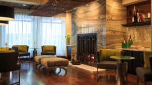 Stylish lobby of the Kimpton Hotel Vintage Seattle, featuring comfortable seating, a fireplace, and a bar, ideal for World Cup hotels and accommodations.