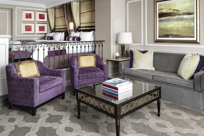 Elegant living room in The Venetian Resort in Las Vegas, featuring plush purple chairs, a gray sofa, and stylish decor, ideal for guests looking for accommodations near the Las Vegas Grand Prix.