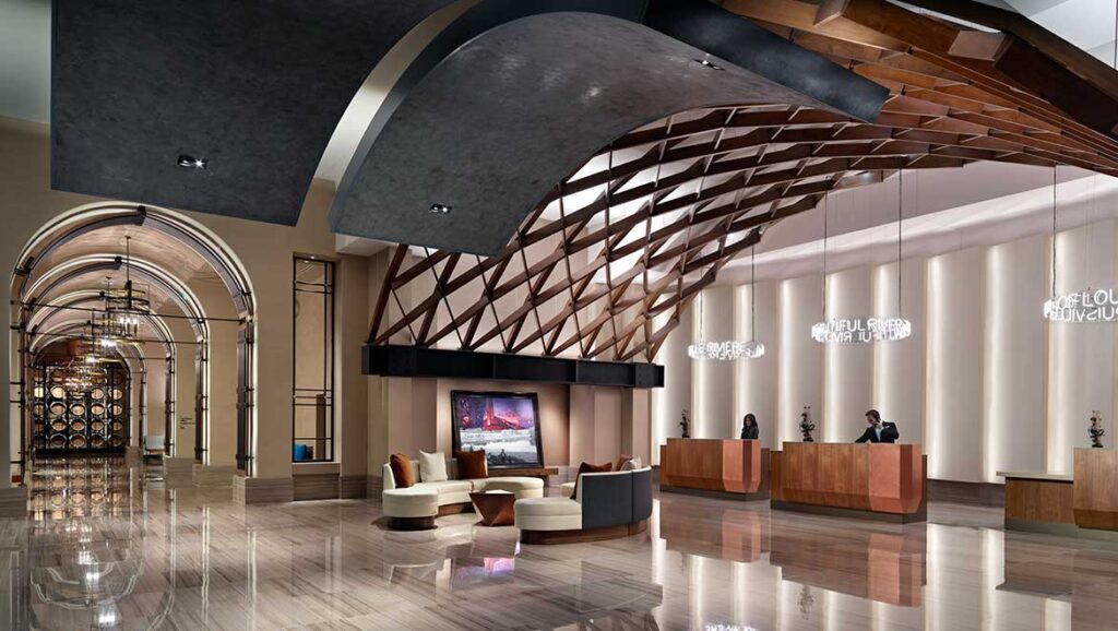 Luxurious lobby of Omni Louisville Hotel featuring sleek, modern architecture and stylish seating areas, ideal for guests attending the Kentucky Derby near Churchill Downs.