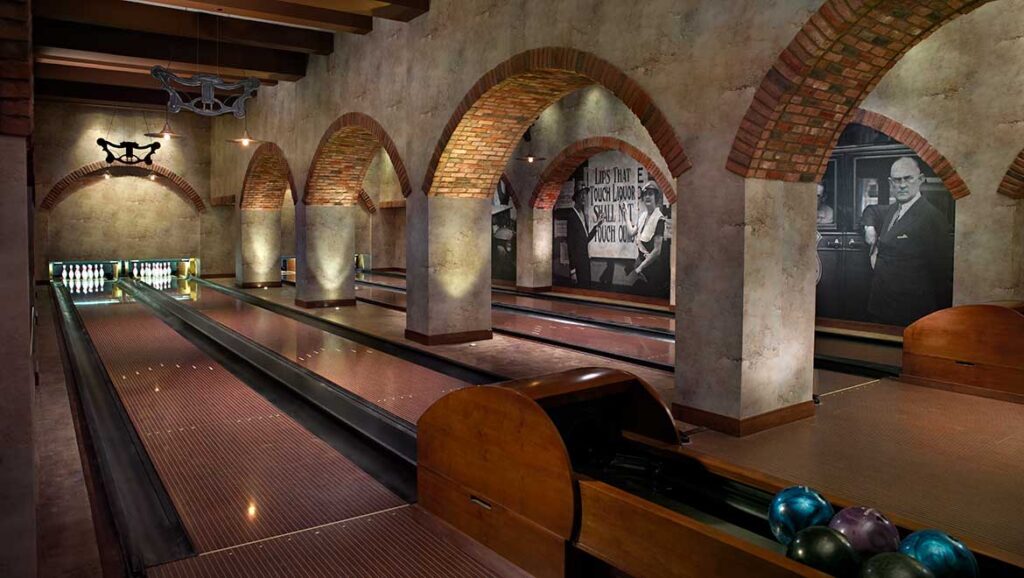 Luxurious bowling alley at Omni Louisville, featuring arched brick ceilings and vintage decor, ideal for visitors seeking upscale accommodations near Churchill Downs.