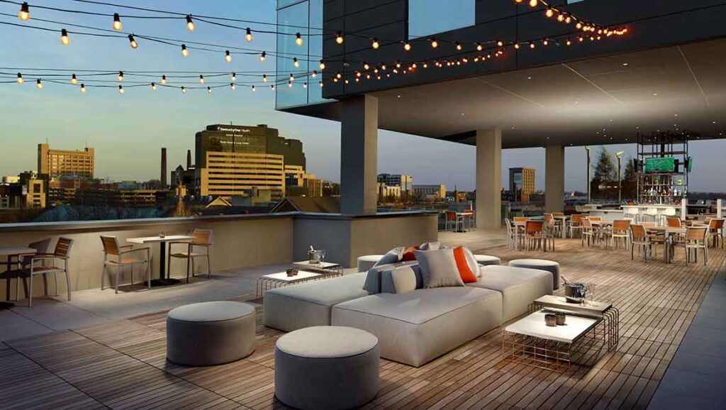 Luxury terrace at Omni Louisville Hotel, featuring comfortable seating and string lights, ideal for guests attending the Kentucky Derby and seeking accommodations near Churchill Downs.