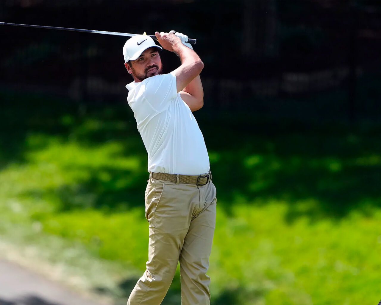 A golfer in white shirt and beige pants swings his club during a practice round at the Masters Golf Tournament in Augusta.