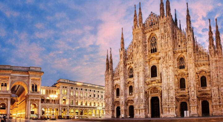 Milan Cathedral and Galleria Vittorio Emanuele II are illuminated at dusk, showcasing iconic architecture central to Winter Games events.