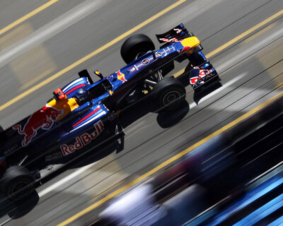 A Red Bull Formula 1 car speeds on a track, capturing the intense action of the Monaco Grand Prix, ideal for those seeking luxury viewing and hospitality packages.