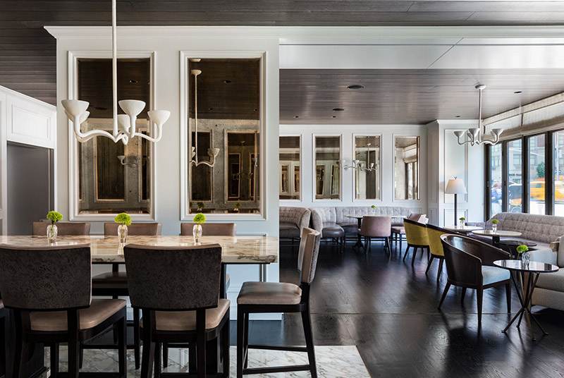 Elegant dining area inside Ritz-Carlton Central Park showcasing a mix of modern and classic design elements, ideal for guests attending the US Open Tennis in New York.