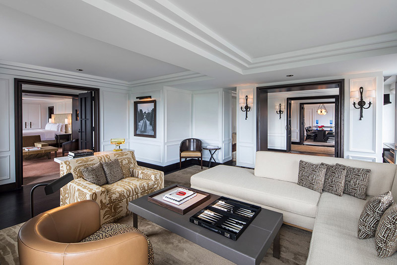 Luxurious suite at Ritz-Carlton Central Park with stylish living area, elegant furnishings, and multiple rooms visible, ideal for US Open Tennis attendees looking for accommodations in New York.