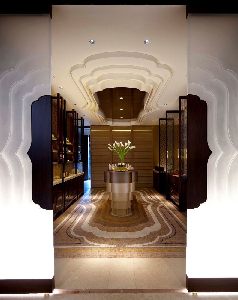 Luxury spa entrance at the Mandarin Oriental in Singapore, featuring elegant interior design, ornate floors, and a stylish reception area.