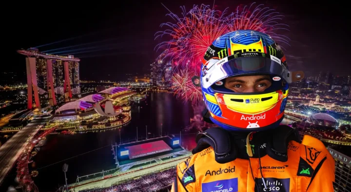 Close-up of a race car driver in a McLaren jumpsuit with an elaborate helmet, overlaid against a backdrop of a lit-up Marina Bay Street Circuit in Singapore with fireworks.