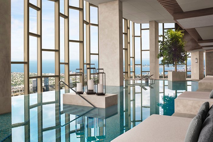 Luxury indoor pool with a serene view overlooking Melbourne's coastline, ideal accommodation near Melbourne Park for the Australian Open.