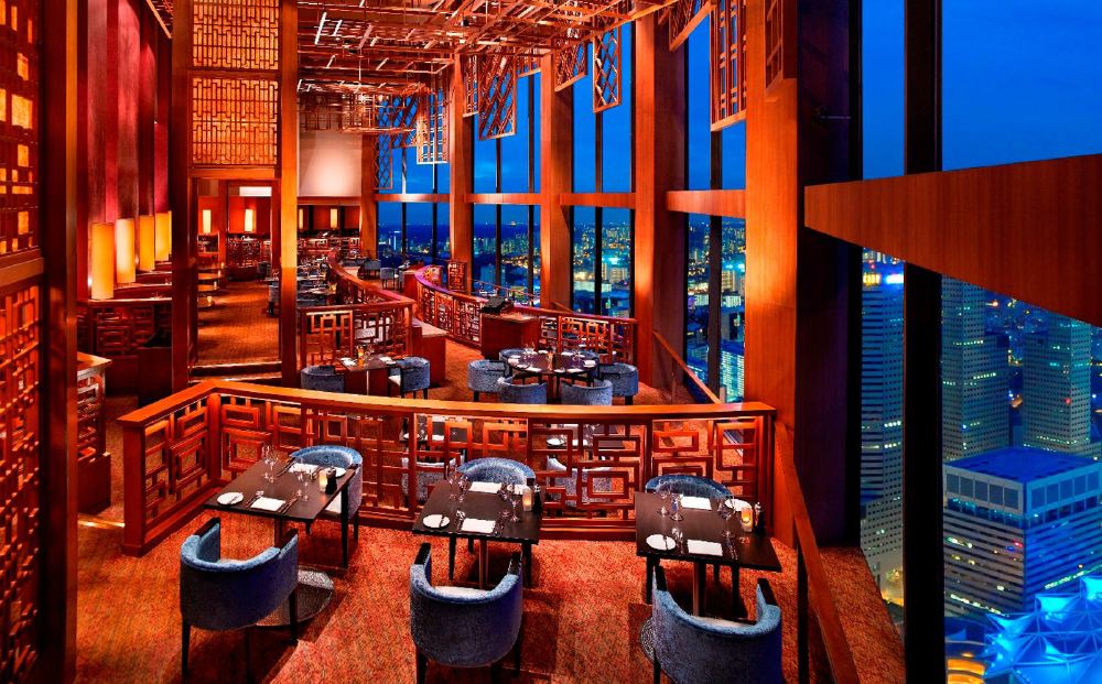 Luxurious restaurant at Swissotel The Stamford, Singapore, offering panoramic city views, ideal for guests visiting during the Singapore Grand Prix.