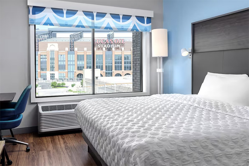 View of Lucas Oil Stadium from a modern room at Tru by Hilton Indianapolis Downtown, showcasing a luxurious accommodation option for guests visiting Indianapolis for events.