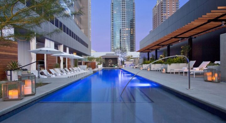 Luxurious hotel pool area in Austin, Texas, with modern lounge chairs and lighting, ideal for US Grand Prix attendees seeking upscale accommodations.