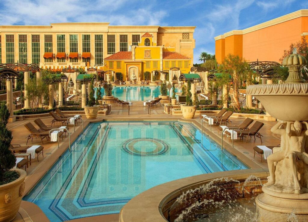 Luxurious pools and lounging areas at The Venetian Resort in Las Vegas, showcasing classical architectural elements and vibrant building facades, perfect for guests visiting for events like the Las Vegas Grand Prix.