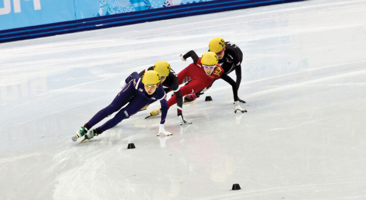 Speed skaters compete in a race, promoting Winter Games ticketing and travel packages, enhancing the excitement for sports fans seeking information on Winter Games rates in Milan and Cortina.
