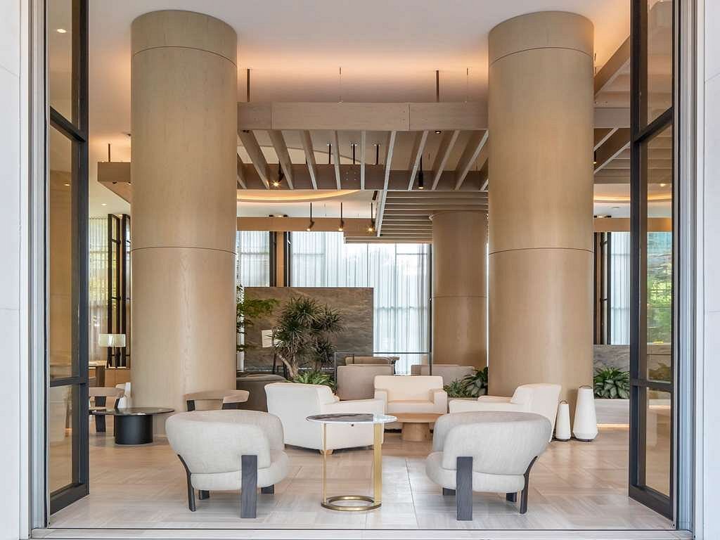 Modern and elegant hotel lounge at Fairmont Century Plaza, Los Angeles, with neutral-toned furniture, columned interiors, and sophisticated lighting, ideal for Summer Games visitors.