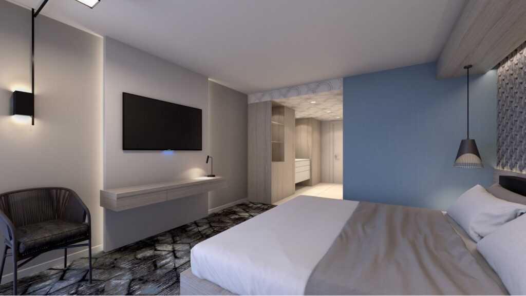 Luxury hotel room at the Renaissance Daytona Beach Oceanfront Hotel, featuring a modern décor with a mounted TV, an accent wall, and stylish lighting, ideal for Daytona Beach hotels seekers.