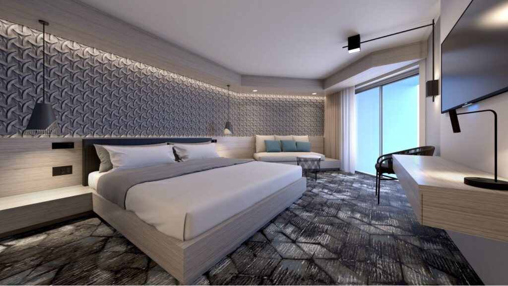 Luxurious hotel room at the Renaissance Daytona Beach Oceanfront Hotel, featuring a king-sized bed, modern furniture, and an ocean view, ideal for Daytona 500 accommodations.