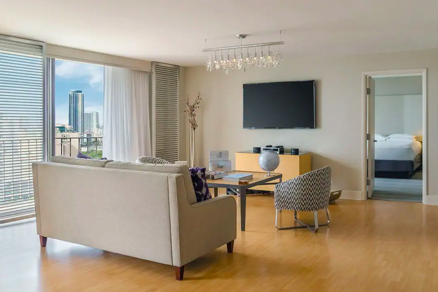Elegant hotel room at Hyatt Regency Miami, featuring modern furnishings with a city view, ideal for Miami Grand Prix Hotels & Accommodations seekers.