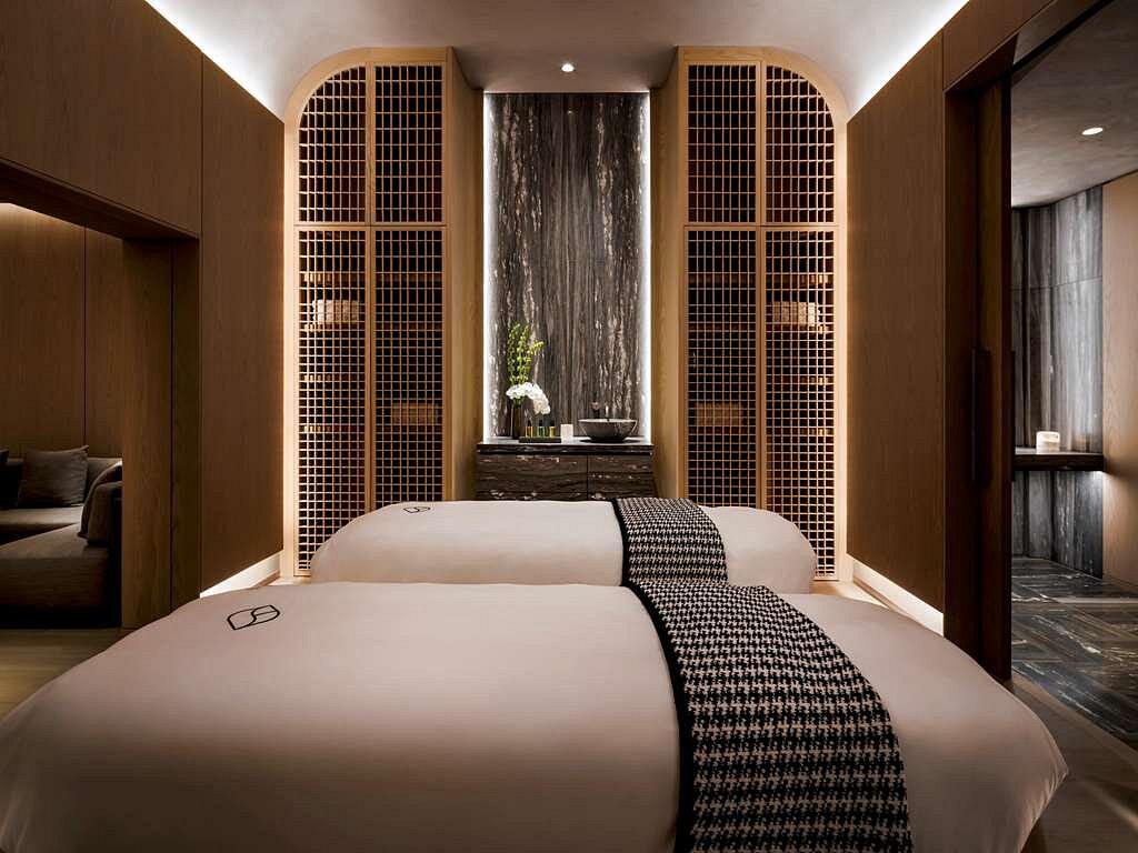 Luxurious spa room at Fairmont Century Plaza in Los Angeles, featuring modern decor and a tranquil waterfall, ideal for visitors seeking accommodations near the Summer Games.