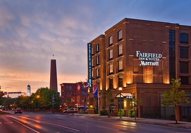 Dusk view of the Fairfield Inn & Suites by Marriott in downtown Baltimore, prominently located amidst historic architecture.