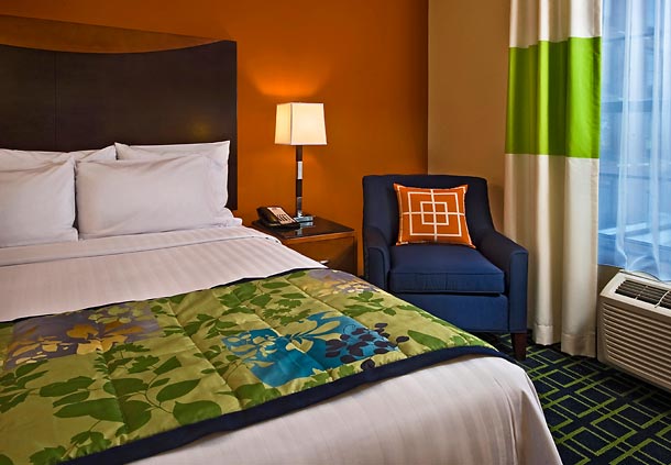 Brightly decorated hotel room at Fairfield Inn & Suites Baltimore Downtown/Inner Harbor, ideal for attendees of the Preakness Stakes seeking accommodations near Pimlico Race Course.