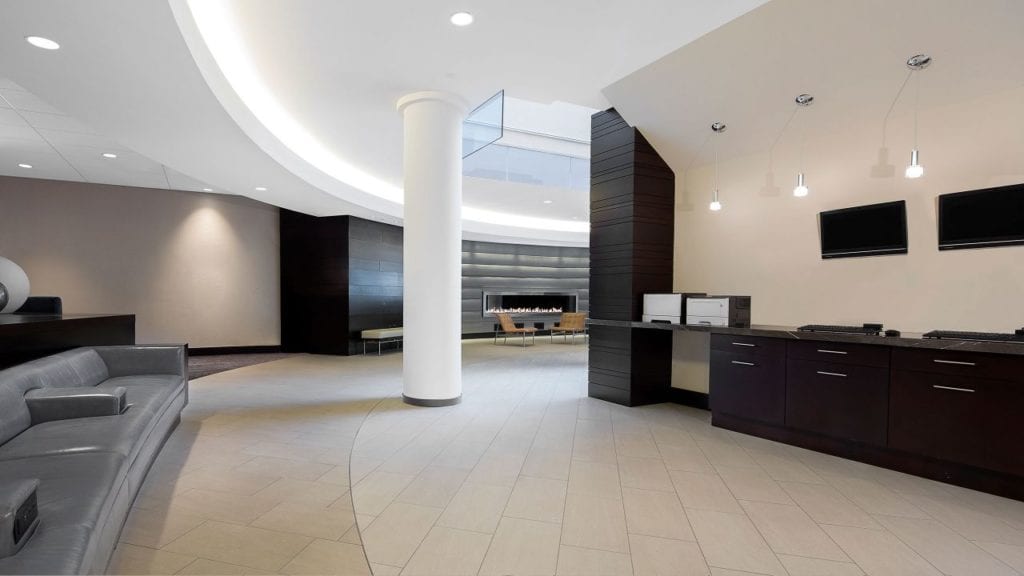 Spacious, modern lobby at the Hyatt Regency Baltimore, featuring sleek furniture and neutral tones, ideal for guests visiting for the Preakness Stakes near Pimlico Race Course.