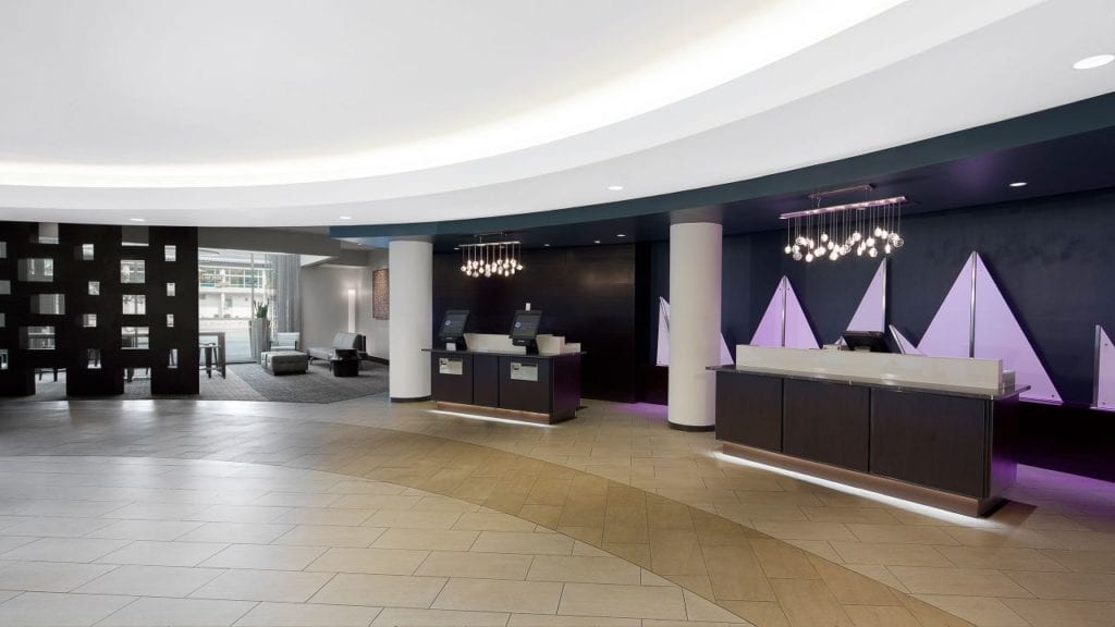 The modern and spacious front desk area of the Hyatt Regency Baltimore, a convenient accommodation choice for visitors to the nearby Preakness Stakes at Pimlico Race Course.