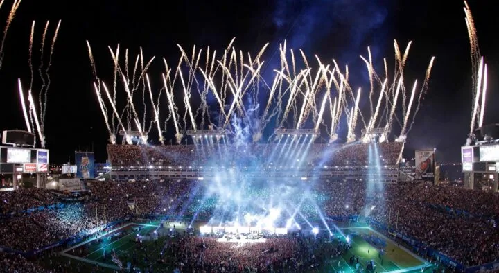 Fireworks illuminate the sky above a packed stadium during a Super Bowl event in Las Vegas, capturing the excitement typical of major sports events like those featured on 'The Savvy Sports Traveler' blog.
