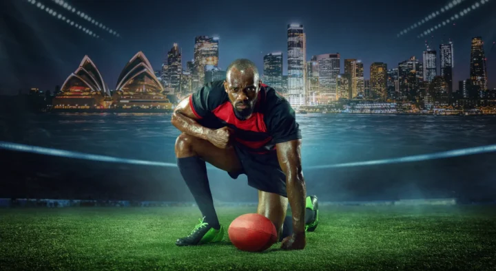 A rugby player crouches ready to play, with Sydney's skyline and the iconic Opera House in the background, promoting rugby travel and ticket packages.
