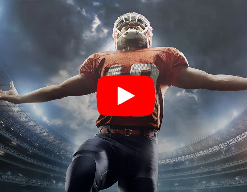 American football player in a stadium with arms outstretched, featuring a play button for a Travel Advisor Webinar on luxury sports travel opportunities.